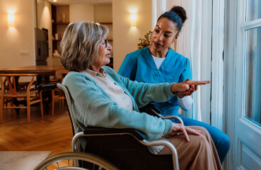 Caregiver assisting wheelchair user with compassion in a home setting