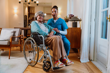 Caregiver providing compassionate assistance to elderly woman in wheelchair at home