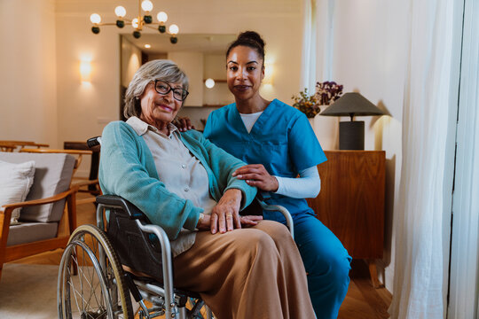 Caregiver providing compassionate assistance to elderly woman in wheelchair