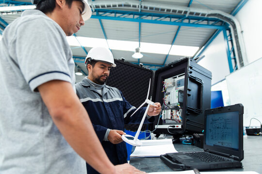 Engineers working with testing equipment in a workshop