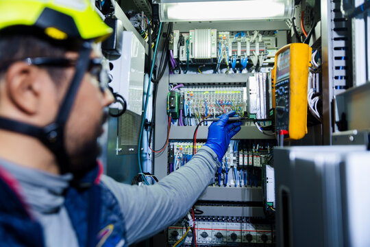 Engineer inspecting medium voltage cell in wind turbine tower