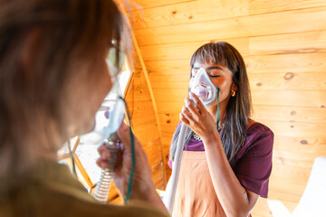 Woman inhaling bee air with breathing mask for apitherapy wellness