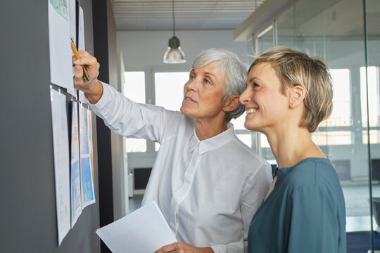 Businesswomen collaborating and brainstorming in modern office