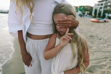 Comforting gesture and emotional support for upset child on beach
