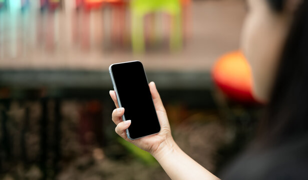 Close up hands holding smartphone with blank screen for mockup,Person using mobile in modern workspace,Concept for App presentation,UI,UX design,Digital Marketing,Technology lifestyle visual