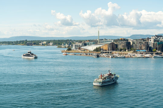 Ferries in Oslo harbor with Astrup Fearnley Museum and city skyline