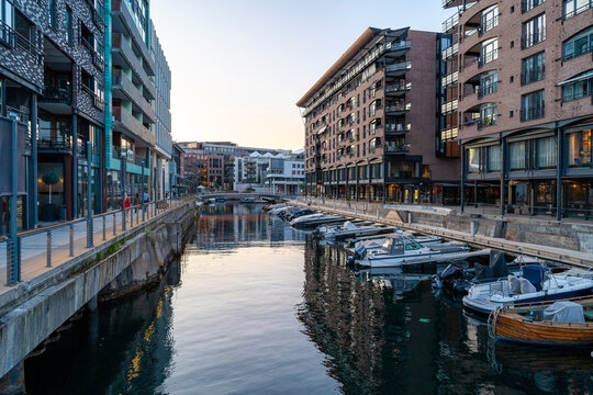 Modern canal and dockside architecture at sunset in Tjuvholmen Oslo