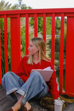 Young woman journaling outdoors for mindfulness and mental well-being