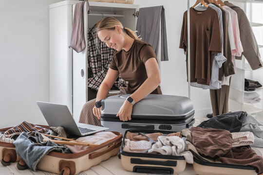 Packing suitcase for travel with capsule wardrobe and remote work setup