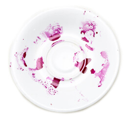 A white plate with purple stains on it