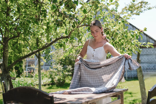 Setting the breakfast table in a garden reflecting family values and tradition