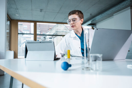 Doctor working confidently in a modern clinic office with technology and lab equipment