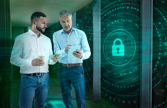 Engineer and colleague analyzing cybersecurity data in server room