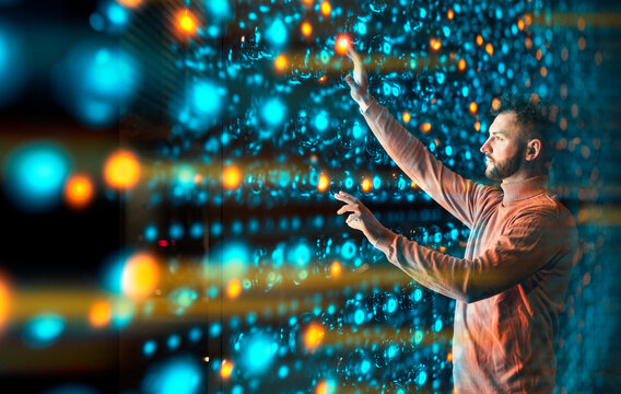 Engineer analyzing data on tablet in illuminated server room