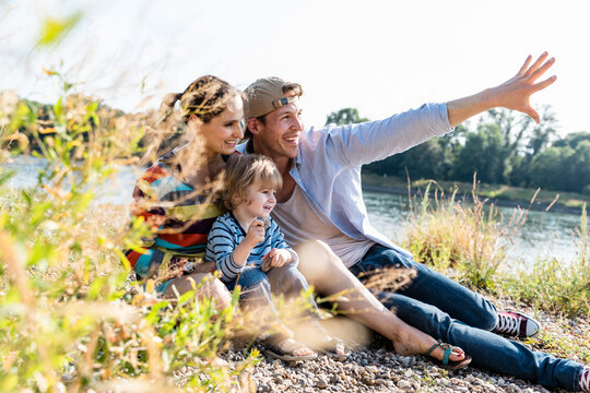 Happy family enjoying time together outdoors by the river