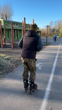 A man rollerblading in a park
