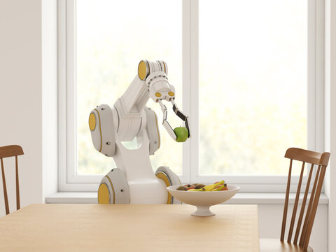 Robot arm picking apple from fruit bowl in modern kitchen