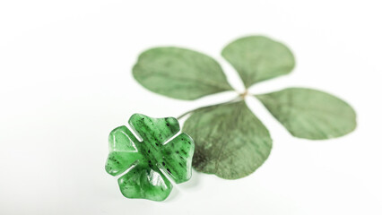 Detail of two four-leaf clovers on background