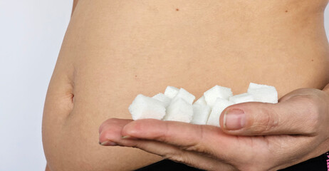 Obese woman holds sugar. Overweight and unhealthy diet and sweets