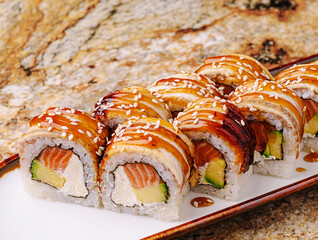 Delicious sushi rolls arranged on a white plate for evening dining