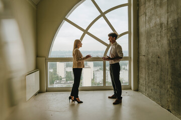 Realtor and client discussing property purchase in modern apartment