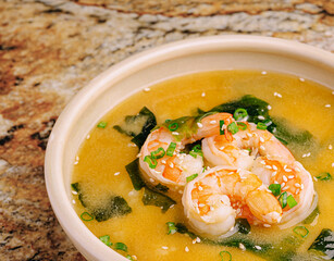 Delicious shrimp soup with seaweed served in a white bowl