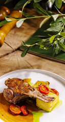 Delicious grilled lamb chop with fresh cherry tomatoes and creamy polenta