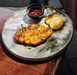 Delicious grilled chicken served with spicy sauce and fried potatoes