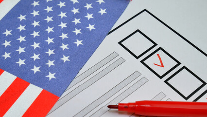 Voter selects choice with red marker on ballot. USA democratic elections. National flag with stars in background. Secure electoral system enables citizens to engage in fair, democratic voting process
