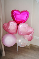 Colorful heart-shaped balloons in a decorated space