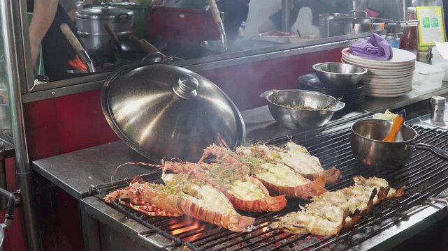  A street food vendor grills fresh spiny lobsters (langustas)