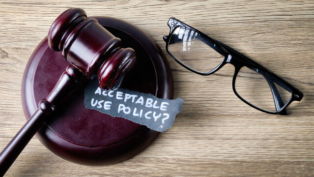 Acceptable Use Policy question on a gavel with reading glasses, symbolizing legal review, compliance, and corporate governance.