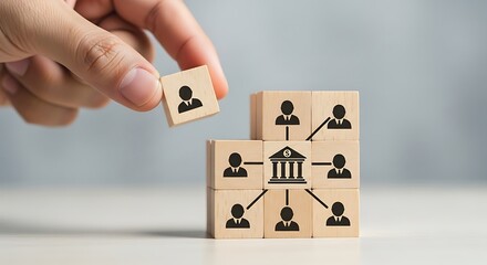 Hand arranging wooden blocks with bank icon and people network structure, decentralize financial system concept