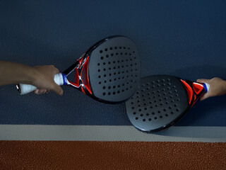 Two Players Holding Padel Rackets