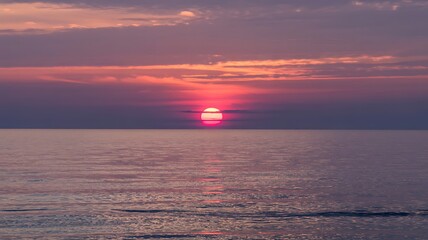 Fototapeta premium Serene Seascape at Sunset with Vibrant Magenta and Orange Sky