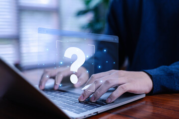 Business professional typing on a laptop with a futuristic question mark icon, symbolizing digital help, online support, problem solving, knowledge search, and modern technology assistance.