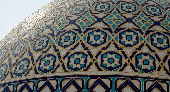 Close up of ornate mosaic dome with geometric patterns and repeating designs
