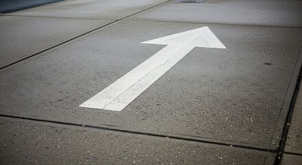 Directional Symbol Painted On Concrete Illustrating Guidance, Navigation, And Guidance