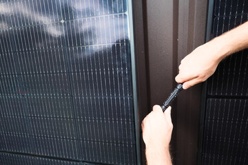 Technician connecting MC4 connectors between solar panels during installation