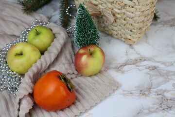 Winter apples and persimmons stand on the table on winter days