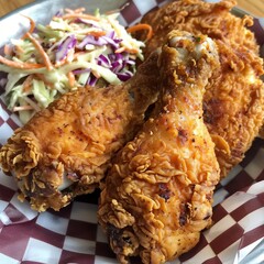 Crispy Golden Fried Chicken Drumsticks and Coleslaw in a Basket