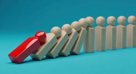 Red figure causes chain reaction among wooden figures conveying influence and leadership concept