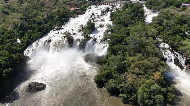 Drone top-down panorama of Binga Falls, Angola, showing multiple waterfalls and swirling whitewater surrounded by lush rainforest and rocky terrain