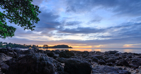 Beautiful sunset over the ocean with a rocky shoreline