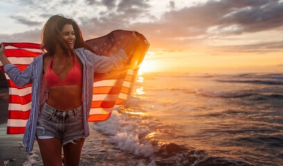 Happy woman running on beach while celebrating independence day and enjoying freedom in USA