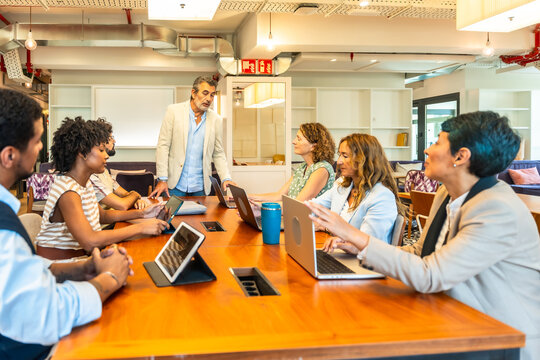 Diverse business team collaborating during meeting in modern office