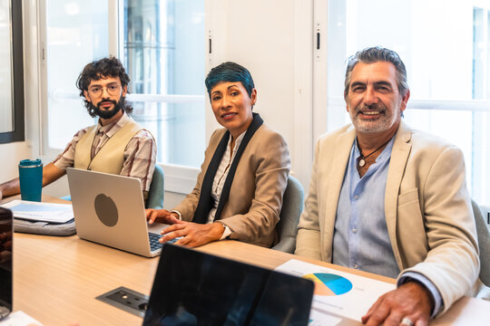 Diverse business people collaborating in a modern office meeting