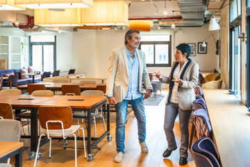 Colleagues collaborating and communicating in modern coworking office