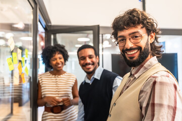 Diverse colleagues smiling and collaborating in modern office