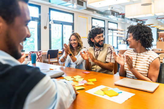 Diverse business team clapping celebrating success during office meeting - Powered by Adobe
